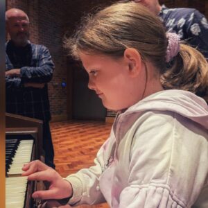 A young girl playing the piano