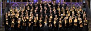 A large mixed choir singing in a cathedral space