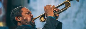 A Black man playing the trumpet