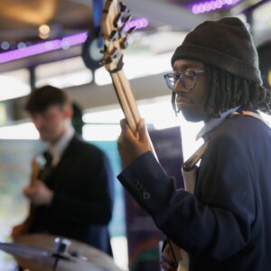Two young guitarists performing on stage