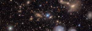 Graphic of a galaxy: black background with white a yellow stars